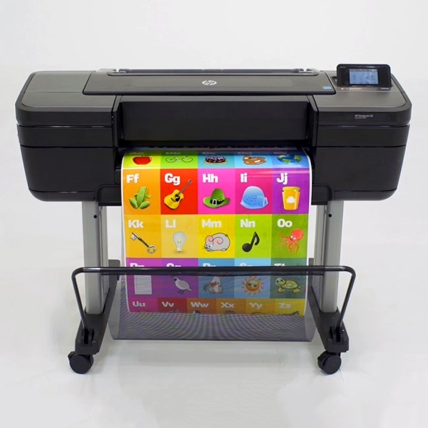 Large format poster print machine displaying colorful educational alphabet chart