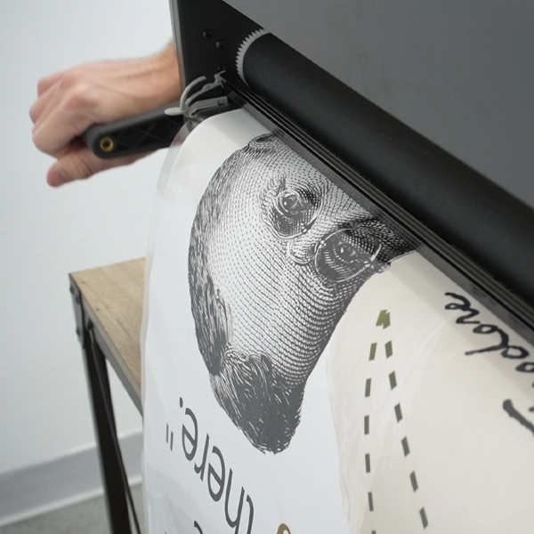 Laminate a printed poster from a poster printing machine