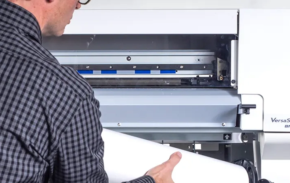 Inserting poster printer paper into Flex Series Poster Printer Cutter