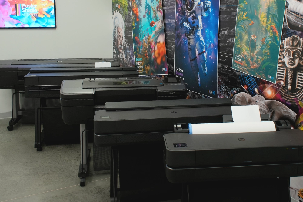 Poster Studio Express — school poster maker studio showcasing wide-format printers, paper options, and StudioCore software