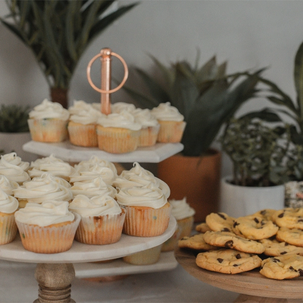 Cupcakes and cookies on display at a school fundraising event