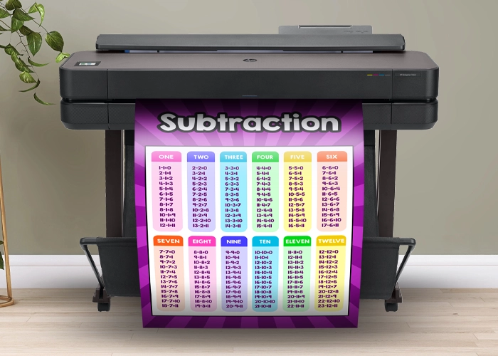 Large poster printer machine printing a colorful subtraction facts poster for educational use.