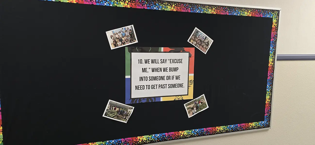 Cozine Essential number 10 poster on a hallway bulletin board at Steve and Linda Cozine Elementary School