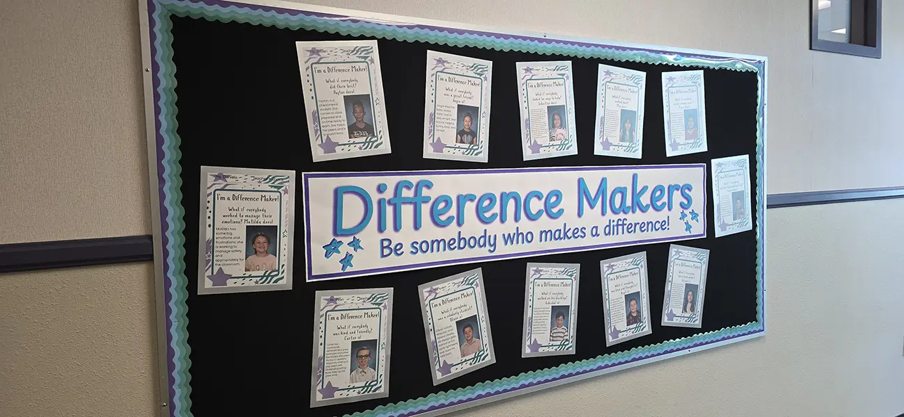 Difference Makers hallway bulletin board with a banner and student recognition posters at Steve and Linda Cozine Elementary School