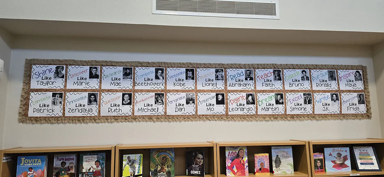 Library bulletin board of role-model posters such as Shine Like Taylor and Read Like Abraham at Steve and Linda Cozine Elementary School
